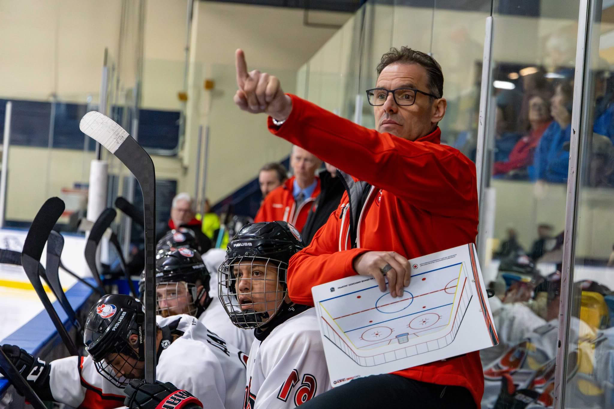 Team Canada Deaf Hockey coach giving instructions to players during training
