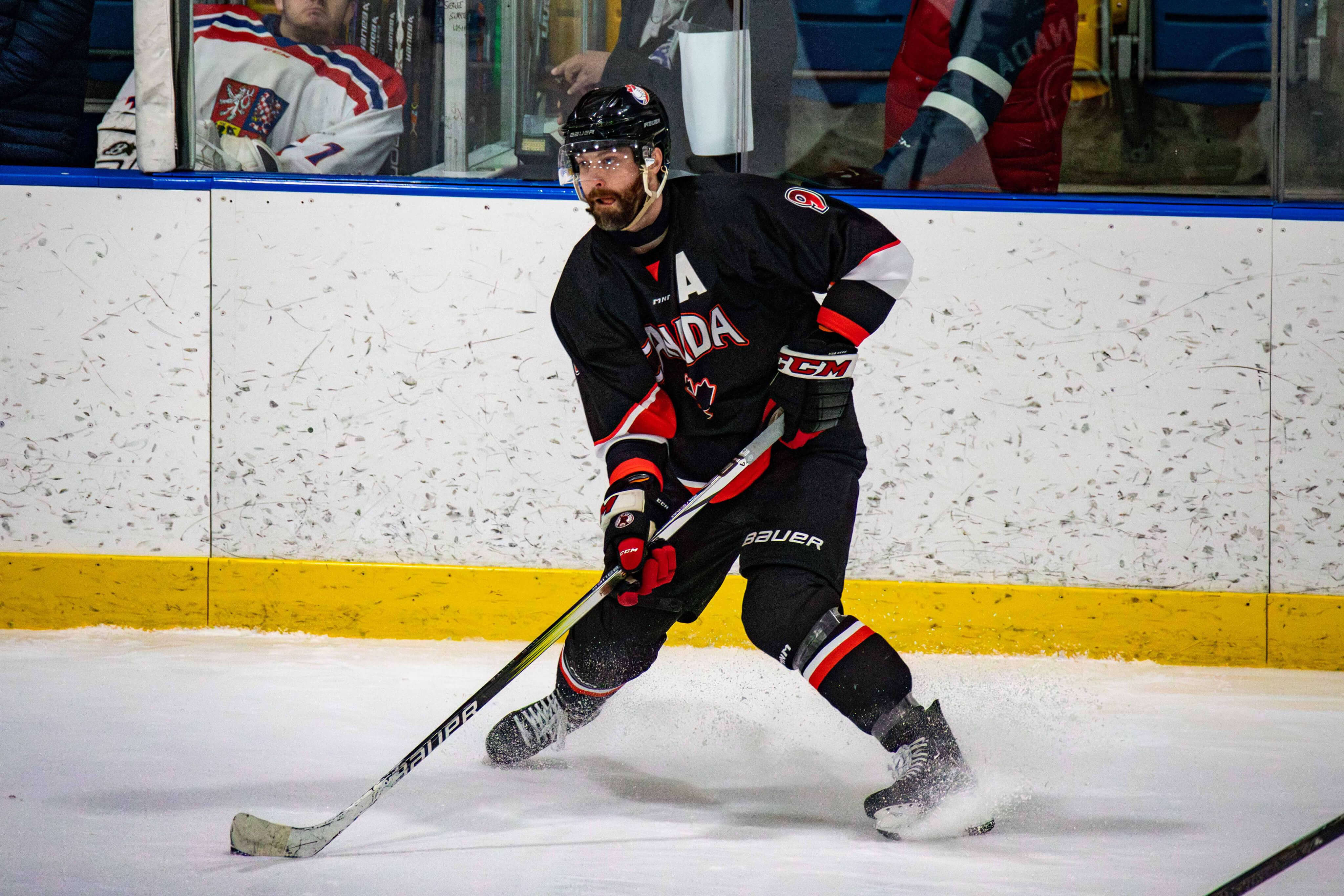 Matthew Sheffield #9 skating with the puck in a Team Canada black jersey