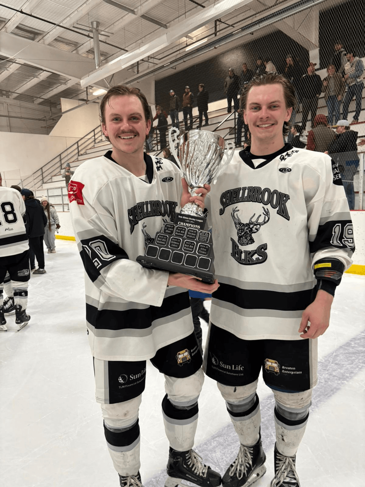Nathan Flodell #20 (right) holding the Twin Rivers Hockey League championship trophy with a teammate
